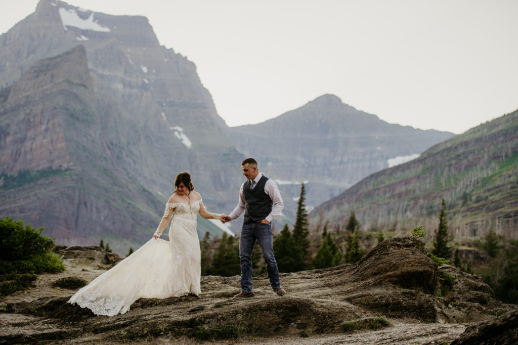 Glacier National Park in Montana is MADE for adventure elopements, and we are made to capture your elopement at the top of those mountains!! If you’re looking to elope in the mountains, we can’t wait to help make your dreams come true. Check out our list of our Top 10 Mountain Elopement Locations Worldwide (must-see hikes included!). Sunrise Glacier National Park Elopement, sun point, East Glacier