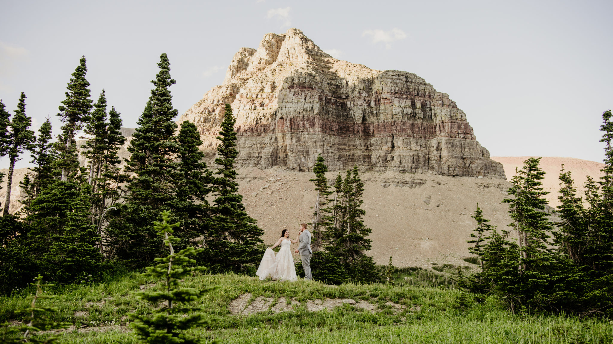 Logan pass glacier national park with bride and groom