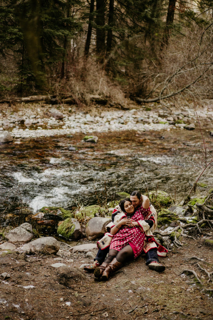 forest engagement photos in Missoula, couple lay together among branches.