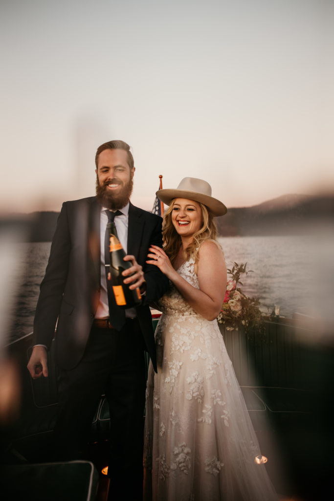 Lake tahoe elopement with couple toasting during their sunset boat tour