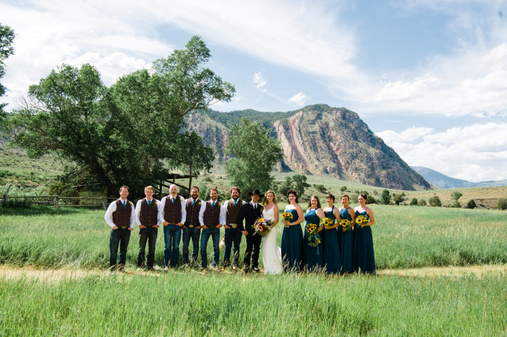 wedding party with green bridesmaid dresses in Yellowstone National Park Wedding