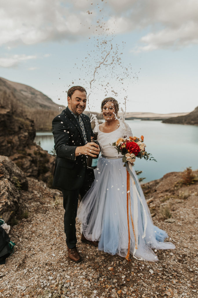 What are the benefits of eloping? We asked what are the reasons to elope from 20 of our real couples! dusty blue wedding dress Glacier National Park wedding at St Mary