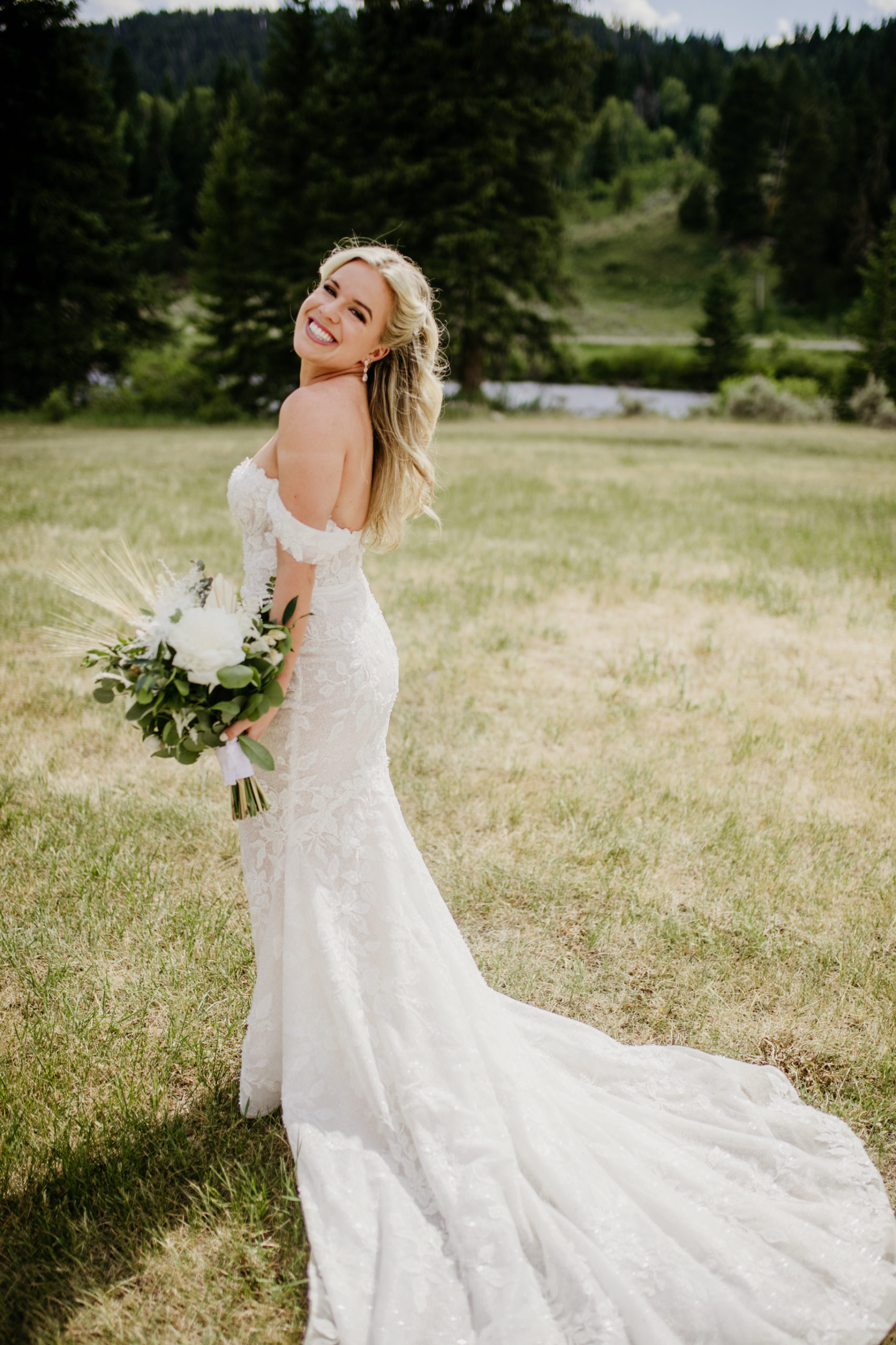 bride with wedding dress and bouquet at the 320 guest ranch wedding