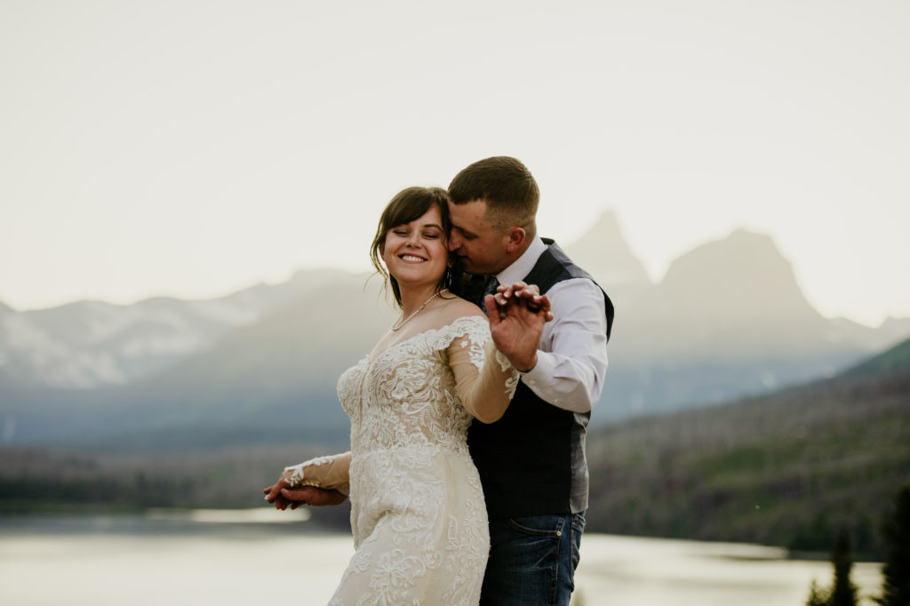 Glacier National Park in Montana is MADE for adventure elopements, and we are made to capture your elopement at the top of those mountains!! If you’re looking to elope in the mountains, we can’t wait to help make your dreams come true. Check out our list of our Top 10 Mountain Elopement Locations Worldwide (must-see hikes included!).  sunrise glacier national park elopement