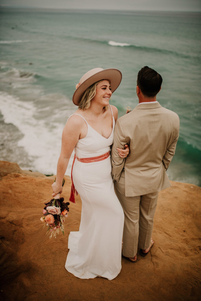 How to elope in Italy. Moody Carlsbad Cliffs Adventure Session. The little beach town of Carlsbad is exploding with boutique shops, great beach life, and lots of tasty restaurants. It's one of our very favorite west coast elopement spots and you'll see why with this moody Carlsbad Cliffs adventure session!