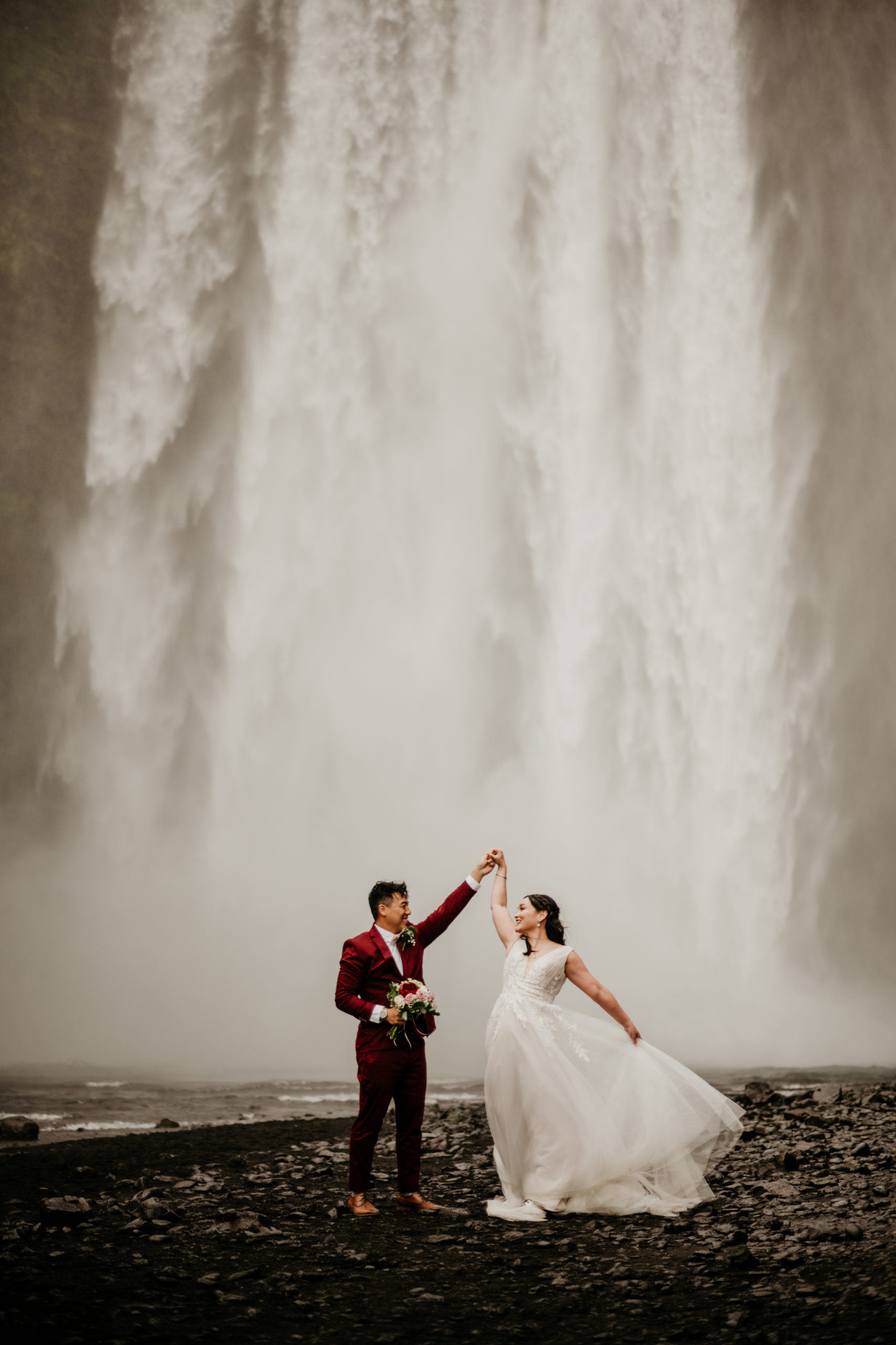During their Iceland elopement at Reynisfjara, a bride and groom explored Skogafoss and seljalandsfoss. Iceland is a one of a kind and adventurous elopement location and MUST be explored! If you're wondering how to elope in Iceland, see how these two did it! 