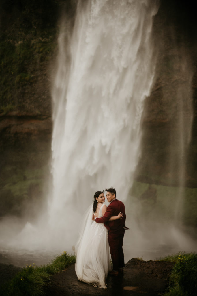 Best of 2022 elopement & wedding photography, Iceland elopement photography at Reynisfjara black sand beach. Elopement photos taken at Skogafoss waterfall. 