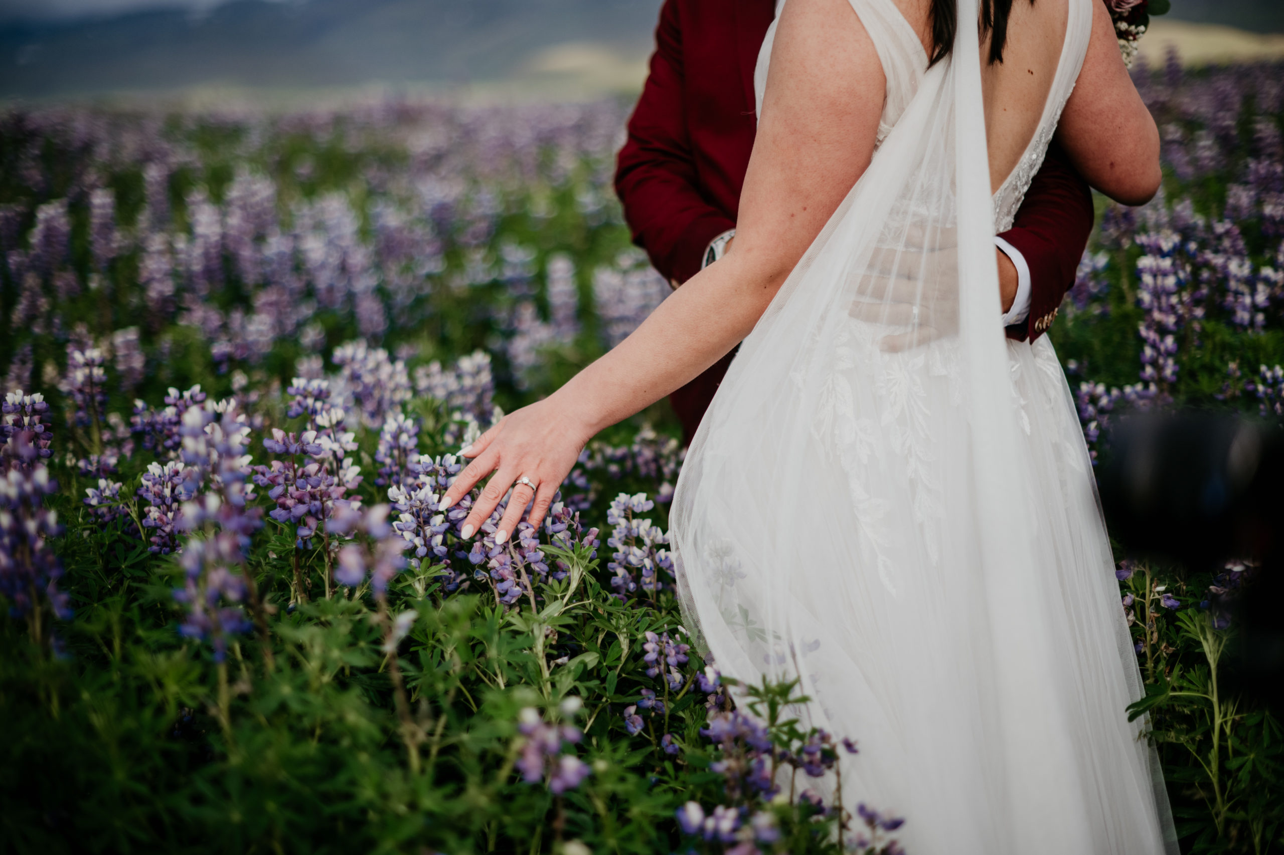 Lupine fields wedding photos! During their Iceland elopement at Reynisfjara, a bride and groom explored the lupine fields of Iceland. Iceland is a one of a kind and adventurous elopement location and MUST be explored! If you're wondering how to elope in Iceland, see how these two did it! 