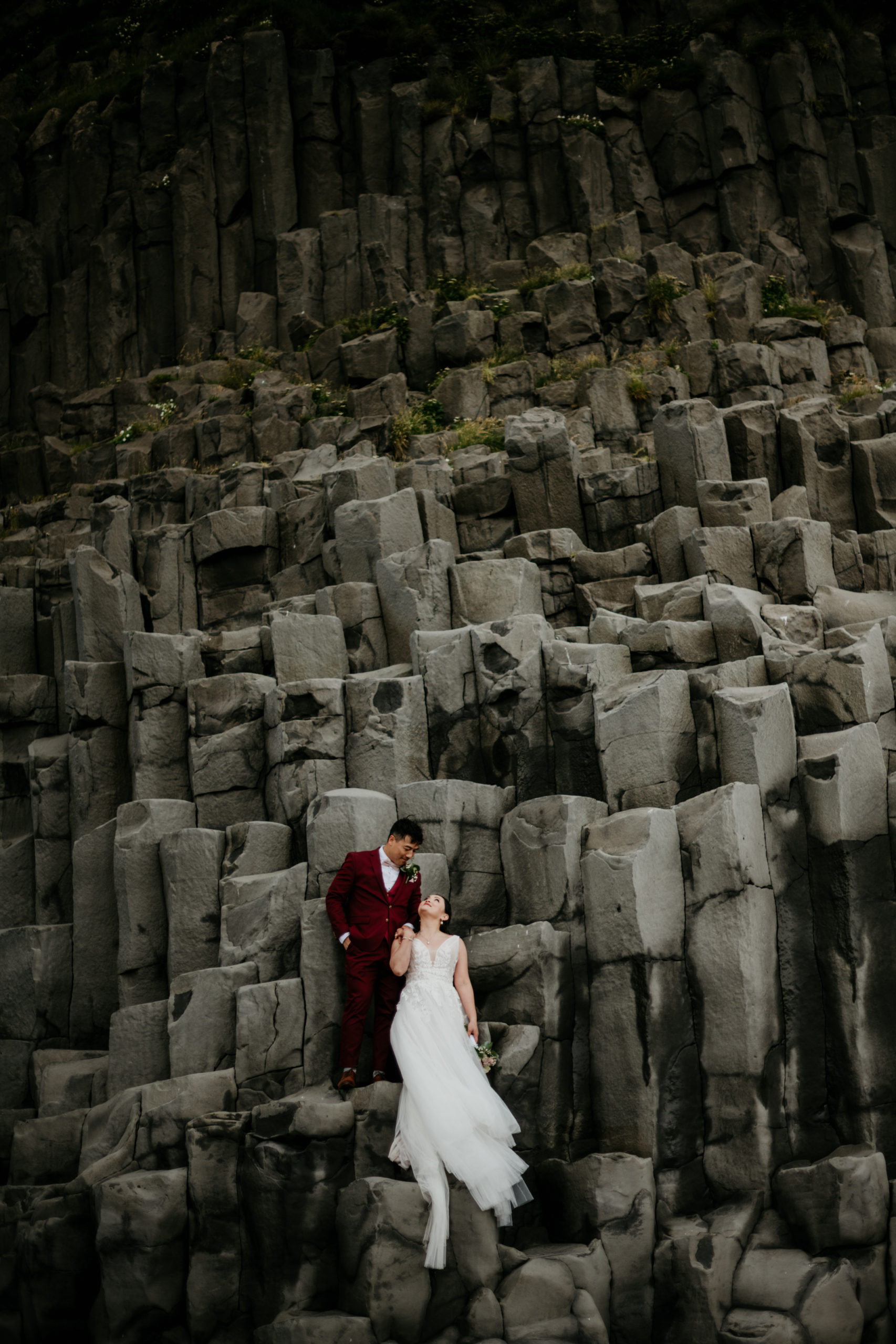 Where to elope in Iceland, Iceland Elopement at Reynisfjara beach. Happy stylish smiling couple walking and kissing in Iceland , on their wedding day.