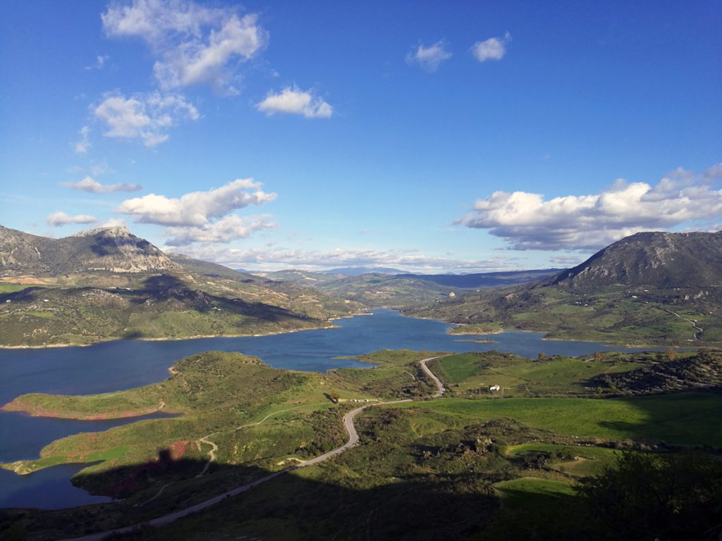 How to elope in Faroe Islands. Aerial view of lake amidst meadows and mountains against clear sky.