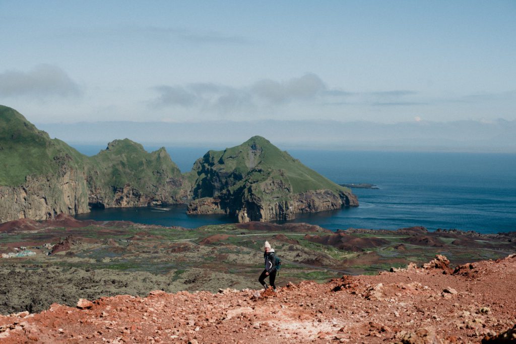Have an eco friendly elopement by following these tips for conscious tourism. 

Iceland travel photos. Hiker walking Westman Islands in Iceland.