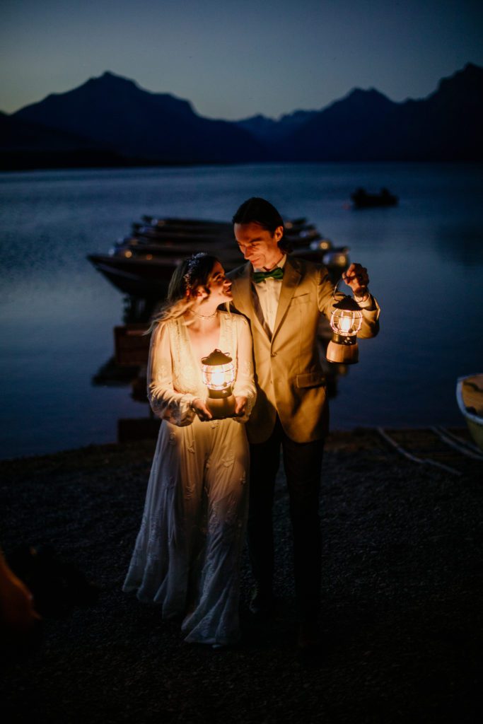 Best of 2022 elopement & wedding photography, Micro wedding in Glacier National Park in the summer. Best places for a micro wedding in Montana. Lantern wedding photo on the lake. 