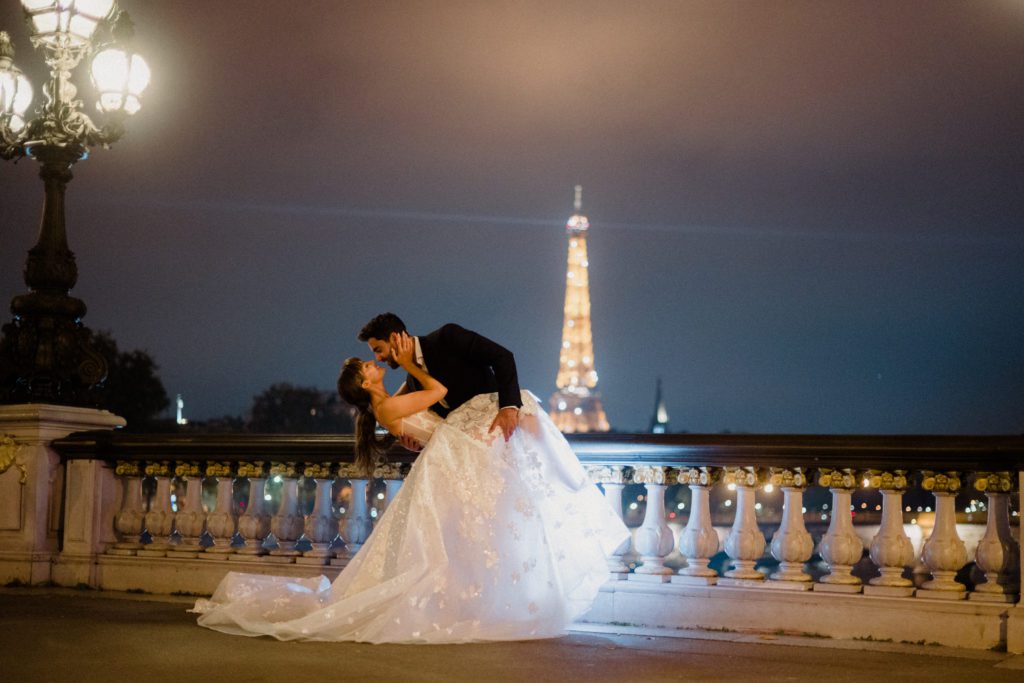 make the transition to elopement photographer with styled shoots. Couple in Paris, France in wedding attire before the Eiffel Tour. 