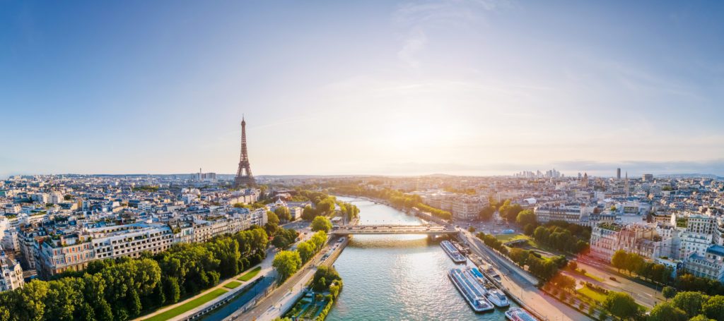 We share options for how to elope in a French chateau as an American and what to prepare. Eloping in Europe is a DREAM!

Paris aerial panorama with river Seine and Eiffel tower, France. Romantic summer holidays vacation destination. Panoramic view above historical Parisian buildings and landmarks with blue sky and sun