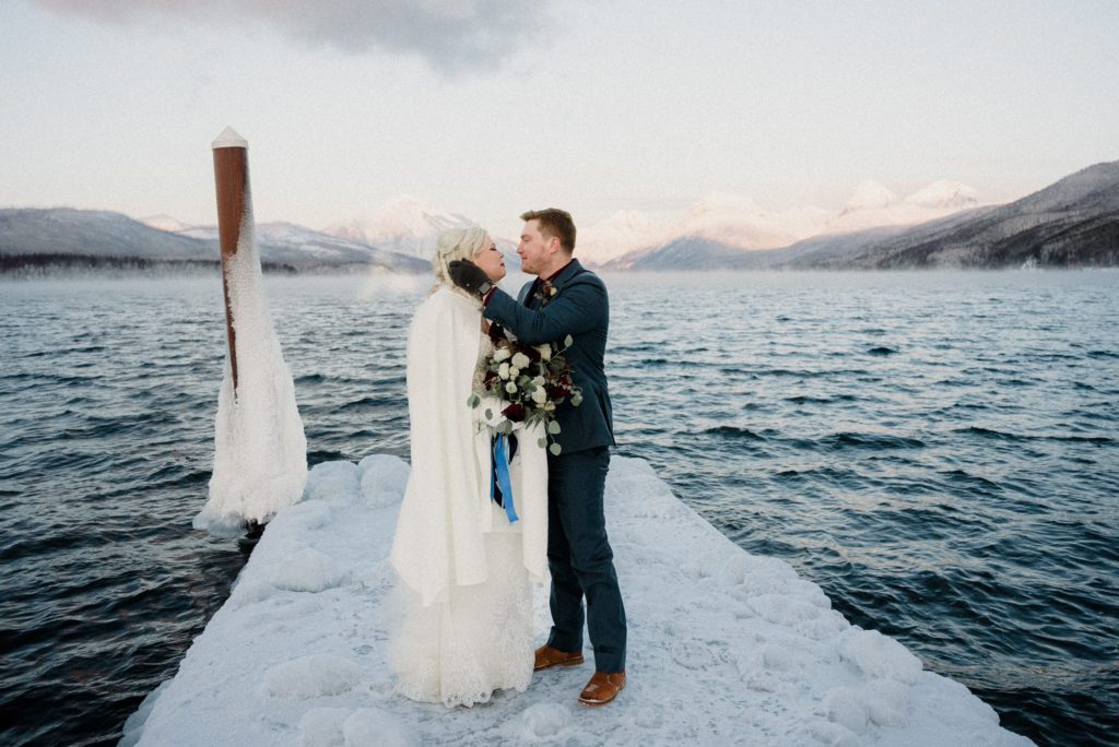 A Glacier National Park Winter Elopement is a one of a kind wedding featuring frozen docks, epic sunsets, and steaming lakes. See the best of Glacier Park!