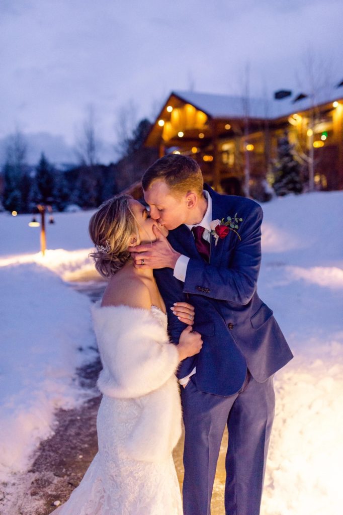 Rainbow Ranch winter wedding in Big Sky Montana. Bride with a white fur outside on her winter wedding day.