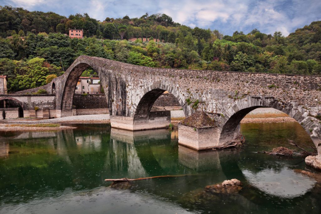 Borgo a Mozzano, Lucca, Tuscany, Italy: the medieval Ponte della Maddalena, known as Bridge of the Devil, which crosses the Serchio river on the ancient pilgrimage route Via Francigena