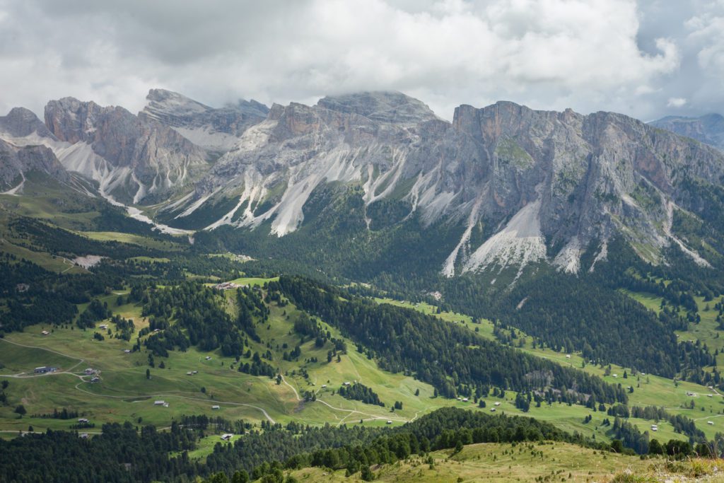 wide view of an alpine pasture among the Dolomites in Val Gardena. Eloping in a foreign country is overwhelming! Americans guide to eloping in Italy to share our REAL plans for our Summer 2023 elopement!