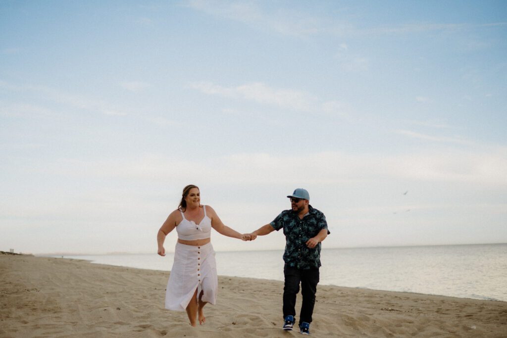 Top Elopement Destinations, Mexico. Couple running in the Mexico sand holding hands. 