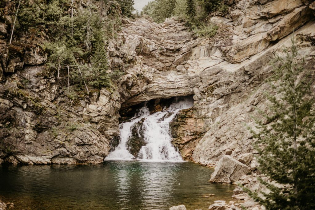 4 ways that this Texas couple came to Montana and did their elopement THEIR OWN WAY! Fall, moody Glacier elopement at Two Medicine! Running Eagle Falls, Glacier National Park. 