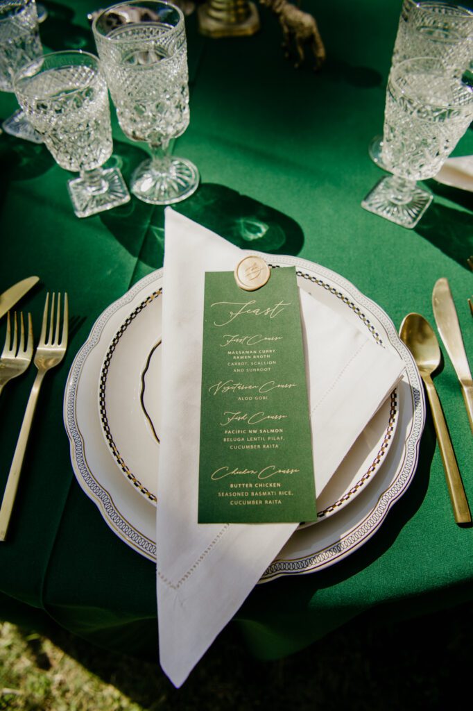 Emerald green wedding table setup and how to design an emerald green wedding. Emerald greens + burgundy details dress up the Montana mountains. Alpine Falls Ranch wedding checks all the boxes for a destination wedding.