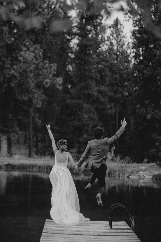 Best Montana wedding venue Alpine Falls Ranch. Bride and groom jump into the lake on their wedding day. 