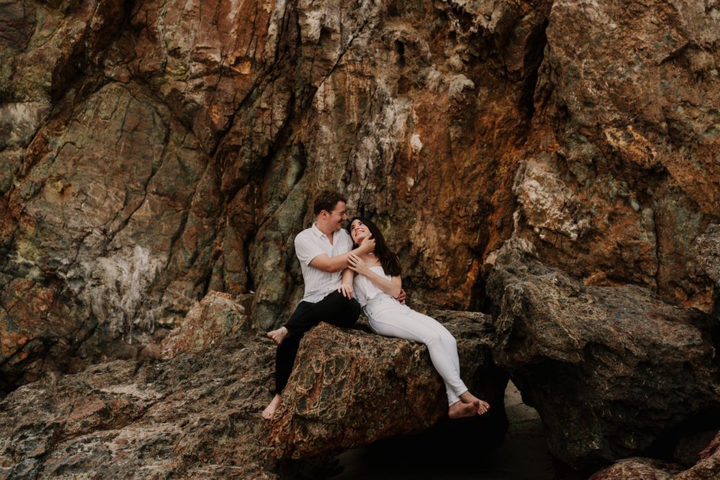 Part one of our Ultimate 2024 Greece Guide, Elope in Greece breaks down the cost, legality, planning and outlines a two day Greece elopement.

engaged couple embrace on rocks