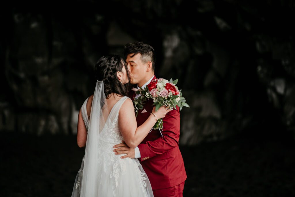 couple having wedding ceremony in a cave. Inspiration picture for an elopement in Greece cave.