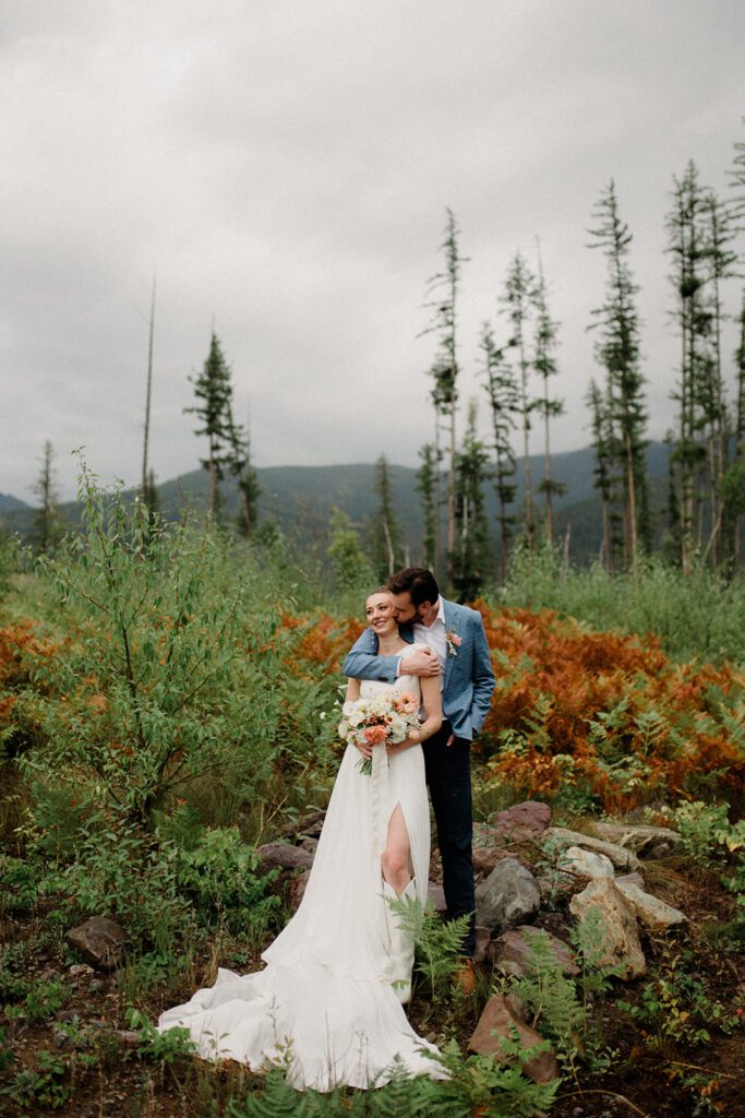 At this Modern Montana Wedding, there are endless wildflowers, moody pond pics, a statement dress and a sprinkle of rain!