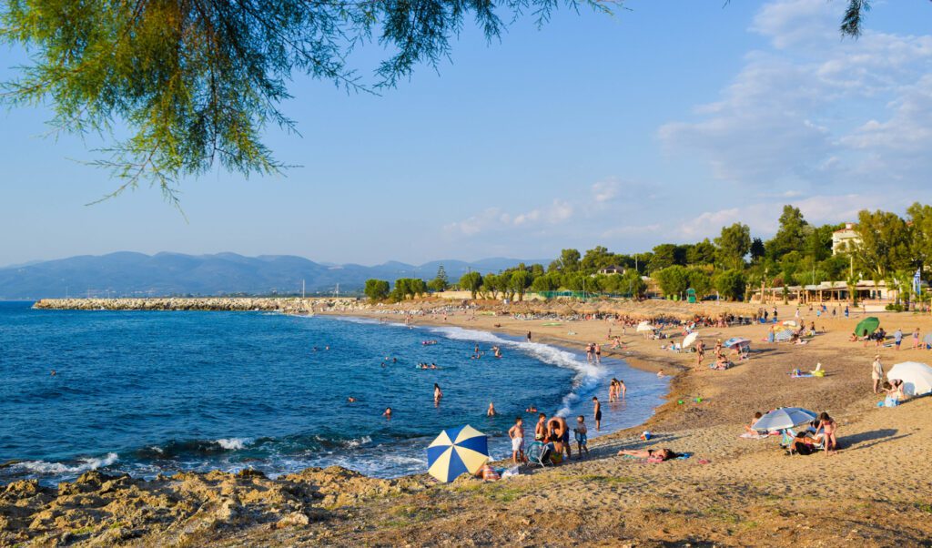 Greece - July 20, 2017: Vacationers sunbathe and swim on the beach of Kyparissia