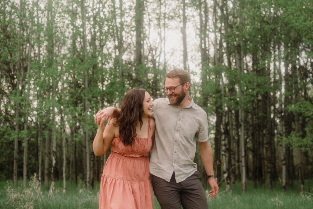 engagement session in Bozeman with mountain views, aspen trees, and candid engagement session photos