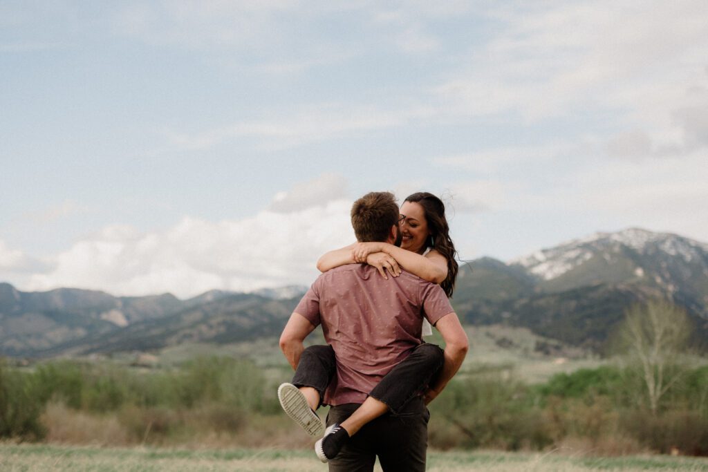 engagement session in Bozeman with mountain views, aspen trees, and candid engagement session photos