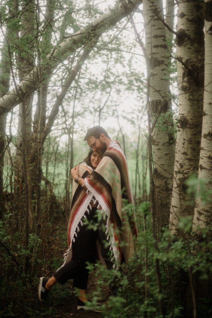 engagement session in Bozeman with mountain views, aspen trees, and candid engagement session photos