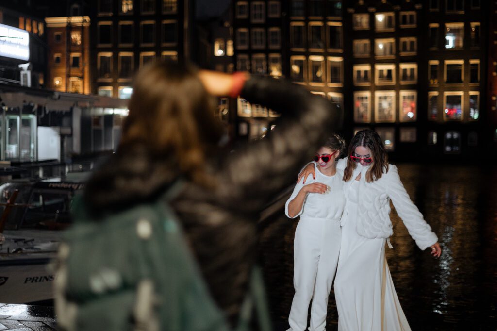 Photographer taking a photo of lesbian couple in Amsterdam. She is building up her associate team.