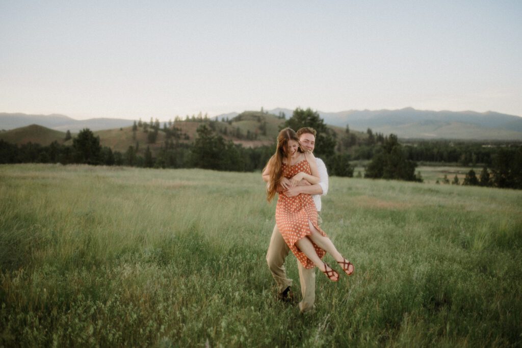 Propose in Montana. Couple at Blue Mountain with man holding woman in a big hug.
