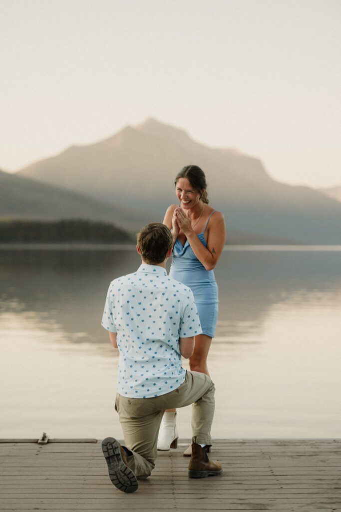 How to Propose in Montana at the top of a mountain without a hike! Couple on wedding day with mountains and clouds in the background. 