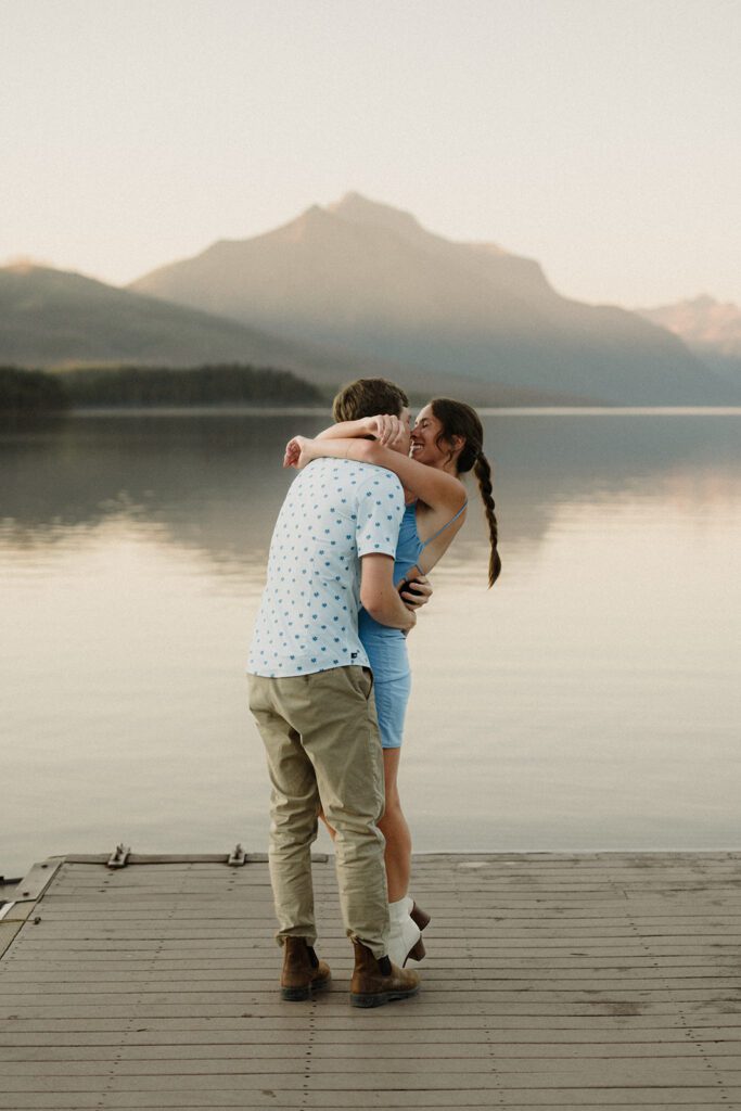Deal with Wedding Stress, man and woman hugging on a dock with mountains in the background. 