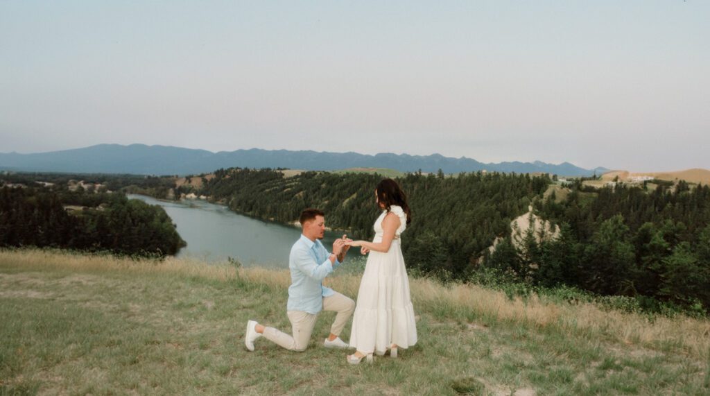 How to Propose in Montana at the top of a mountain without a hike! Couple on wedding day with mountains and clouds in the background. 