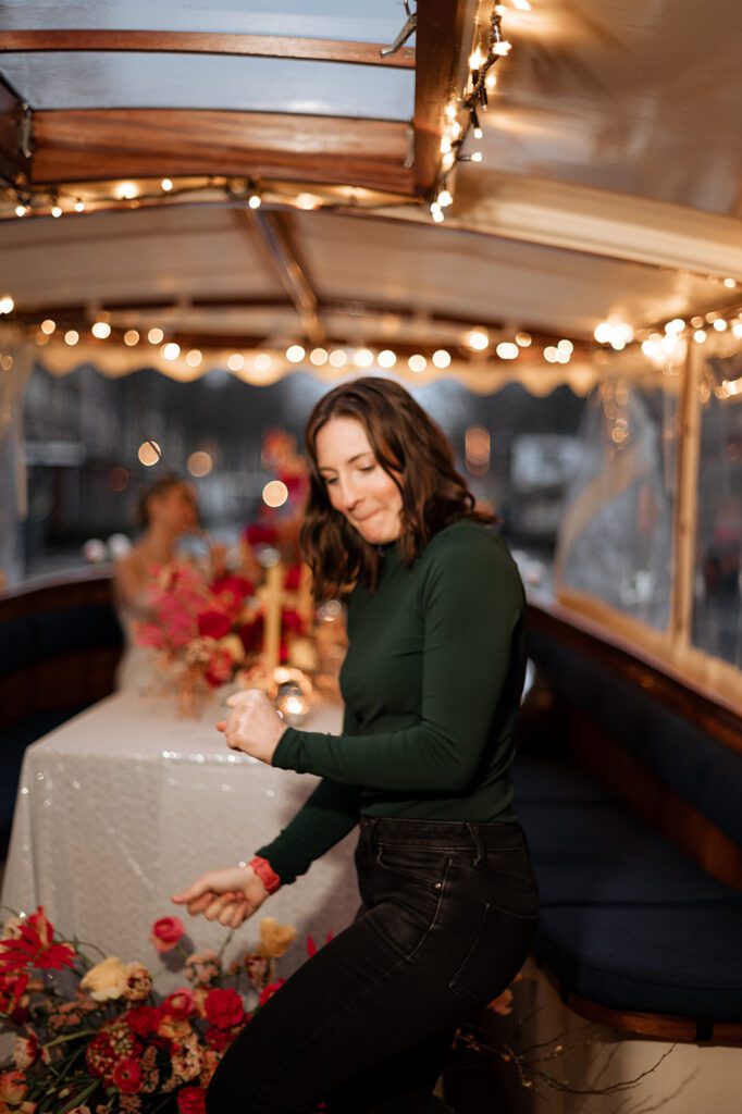 how to work less in your photography business. Photographer dancing on a boat in Amsterdam.