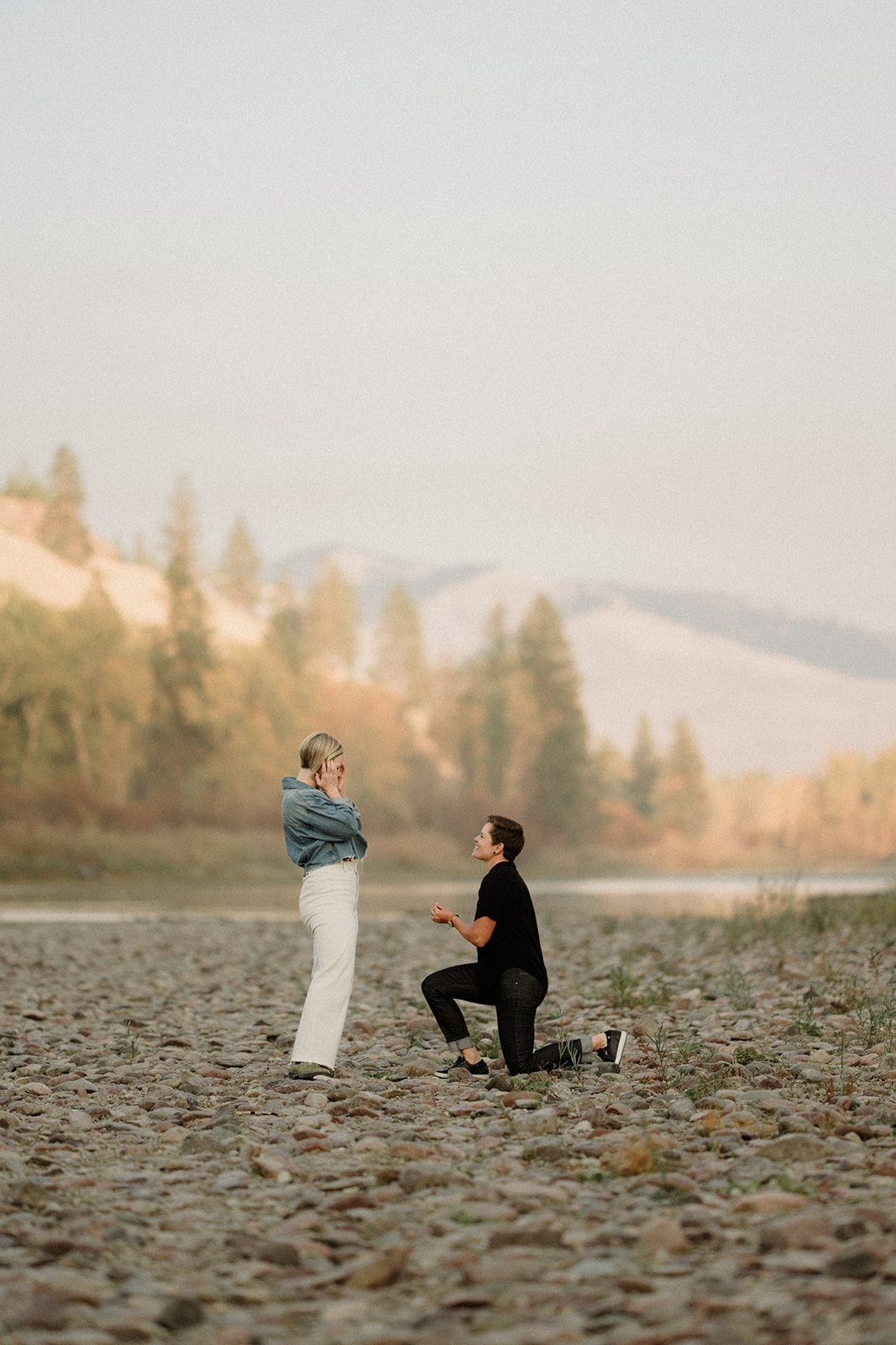 This lesbian proposal in took place in Missoula, Montana. One woman proposing to her partner on the shore line.