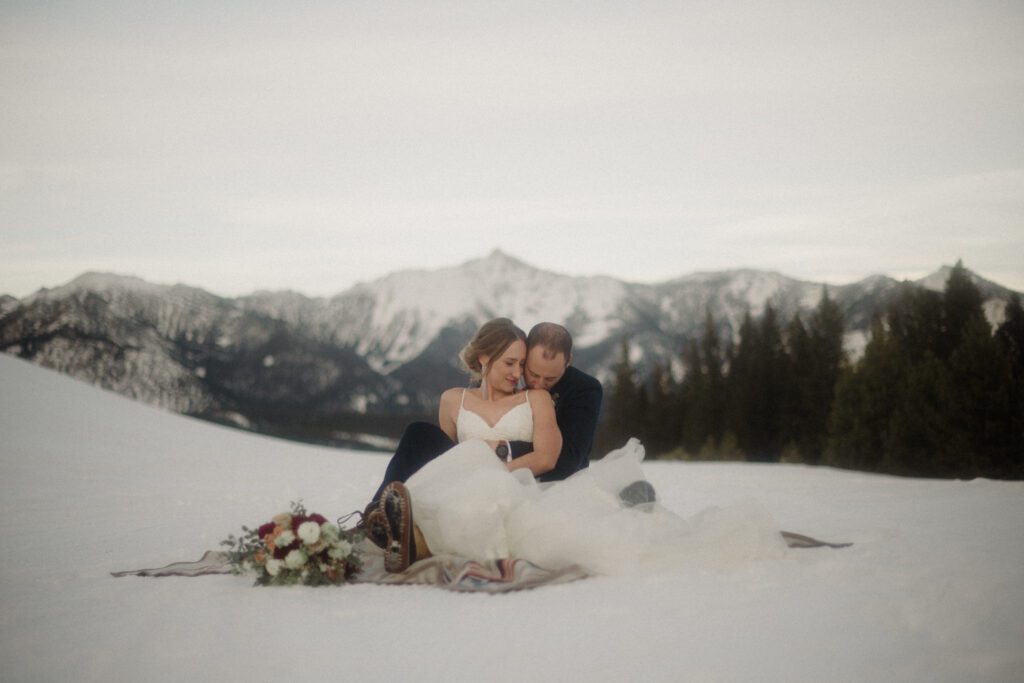 An adventurous winter elopement in Montana features frozen waterfalls, ski lifts, reindeer, and stunning star photos. Explore their epic day! Get more info on Where to stay in Big Sky Resort!