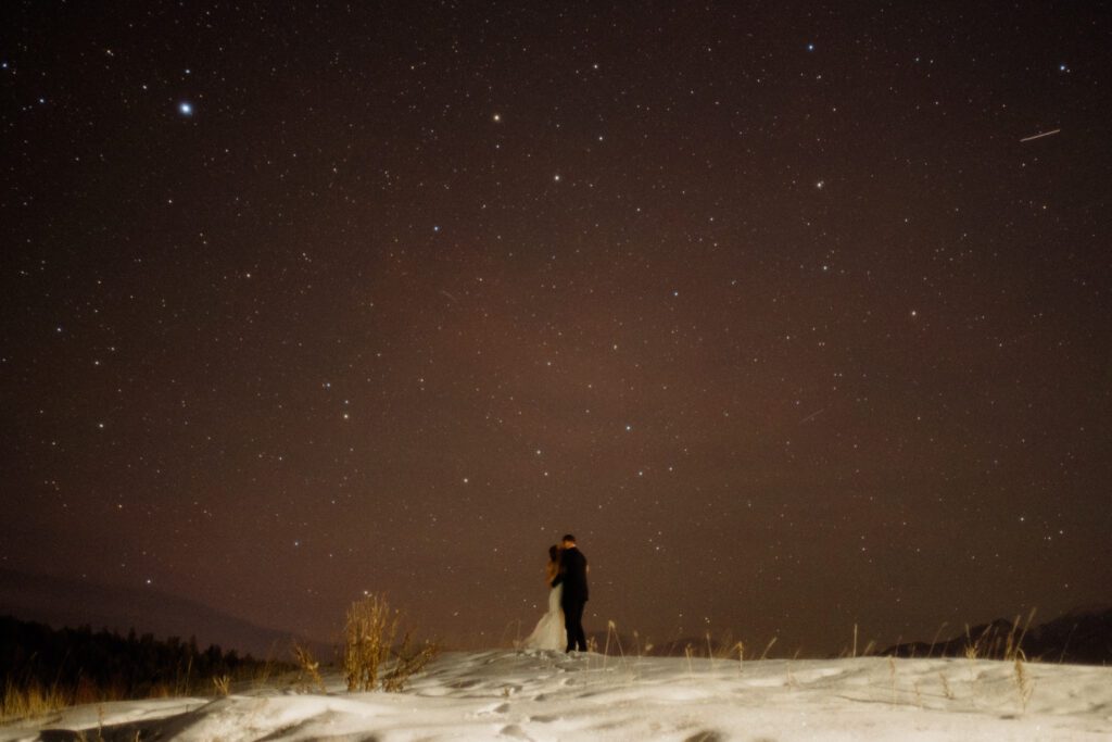 An adventurous winter elopement in Montana features frozen waterfalls, ski lifts, reindeer, and stunning star photos. Explore their epic day! Get more info on Where to stay in Big Sky Resort!