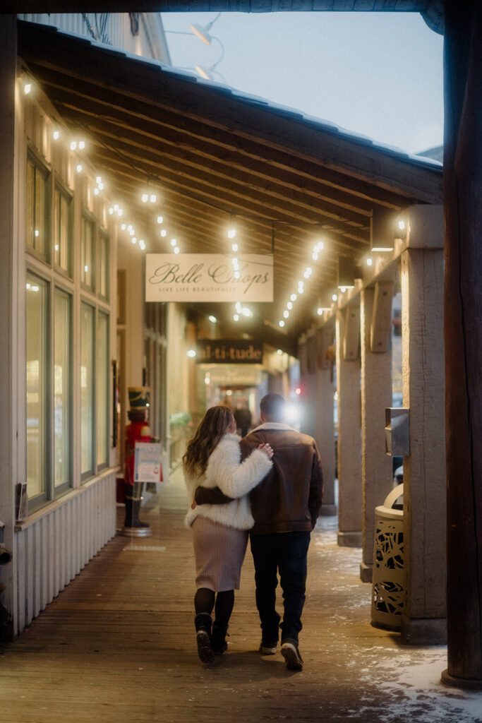 Proposal in Grand Teton. Man and woman walking Downtown together, hand in hand during the evening glow.
