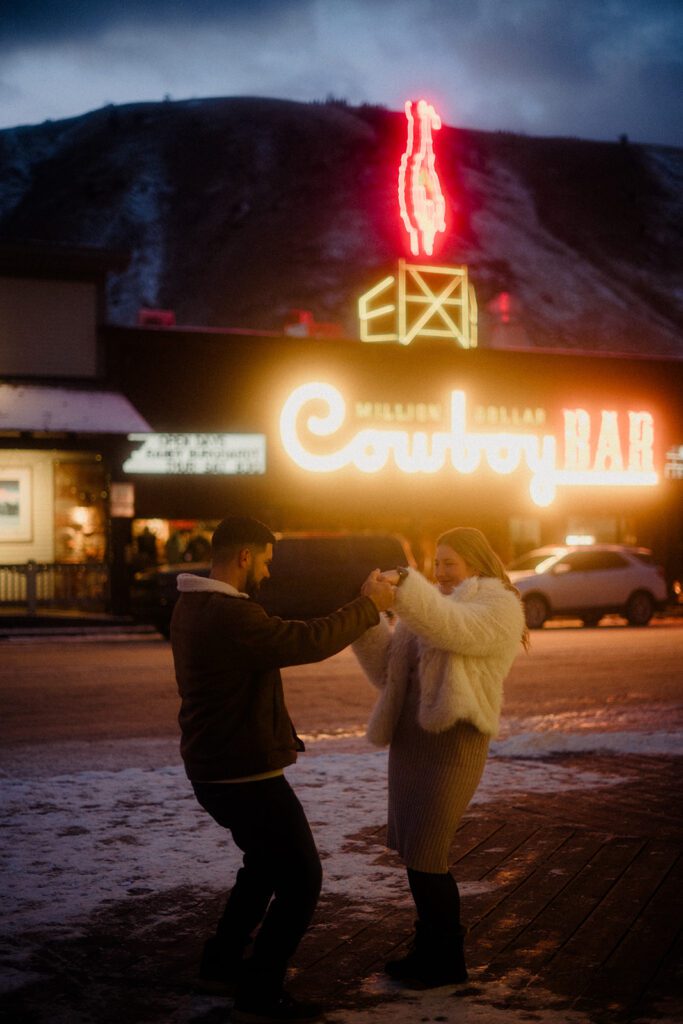 Proposal in Grand Teton. Couple celebrating after outside the Country Bar in Jackson Hole, Wyoming.