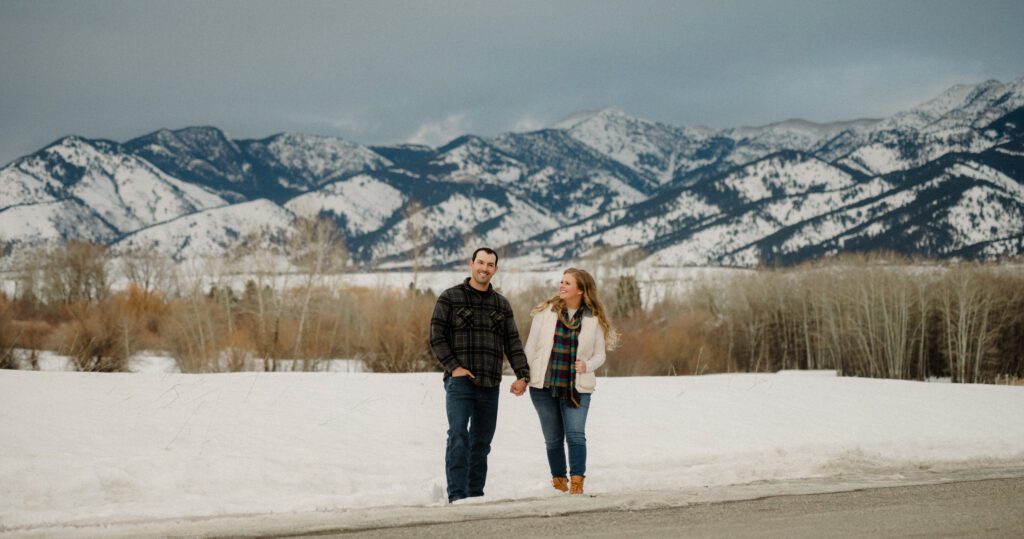 Experience the magic of a winter Bozeman Montana engagement with epic mountains, major Western vibes, and champagne pops.