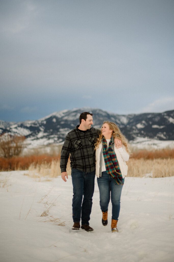 Experience the magic of a winter Bozeman Montana engagement with epic mountains, major Western vibes, and champagne pops.