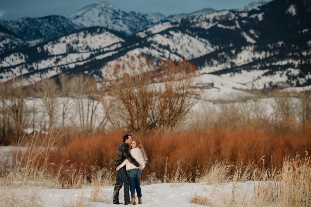 Experience the magic of a winter Bozeman Montana engagement with epic mountains, major Western vibes, and champagne pops.