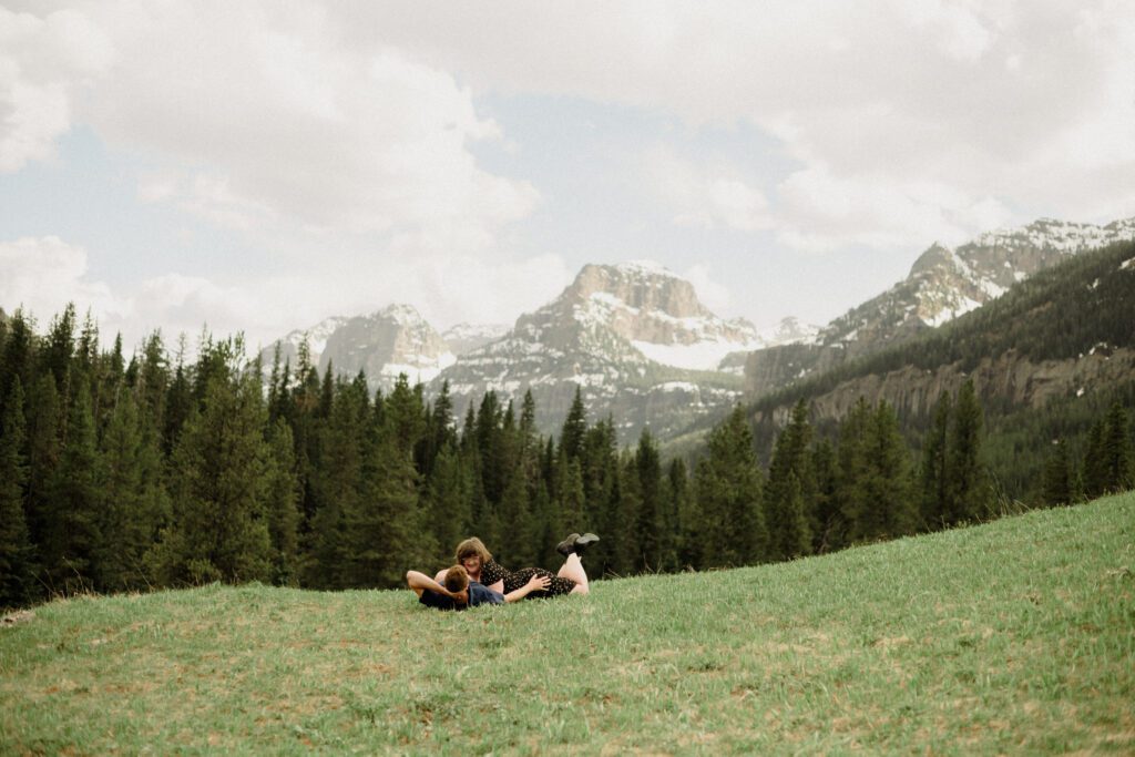 Couple laughing during engagement photos in Bozeman at Hyalite Canyon