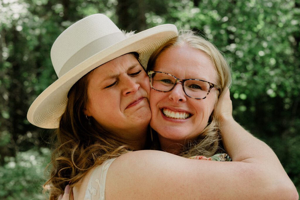 How to have a micro wedding in Glacier National Park. Close up of bride holding her smiling mom's face close.