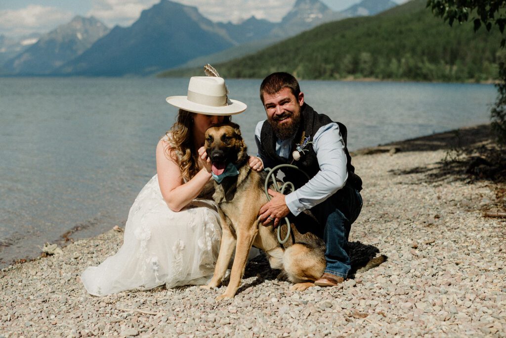 How to have a dog friendly elopement. Bride kissing side of dog's head while groom holds dog.